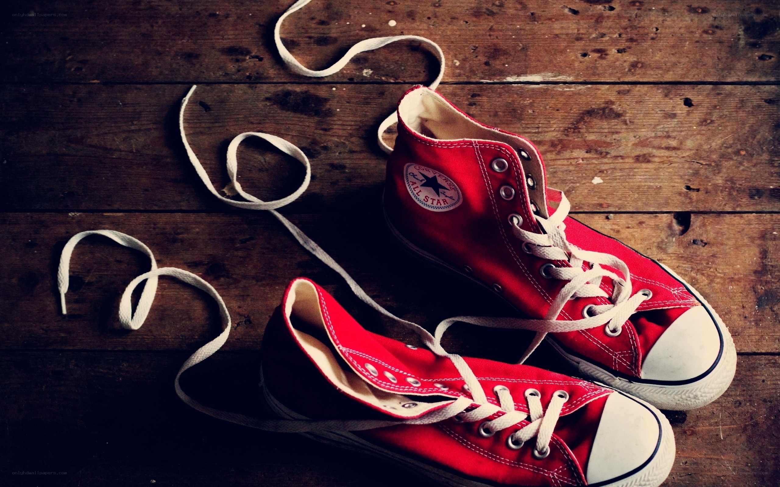 Red sneakers on wooden floor