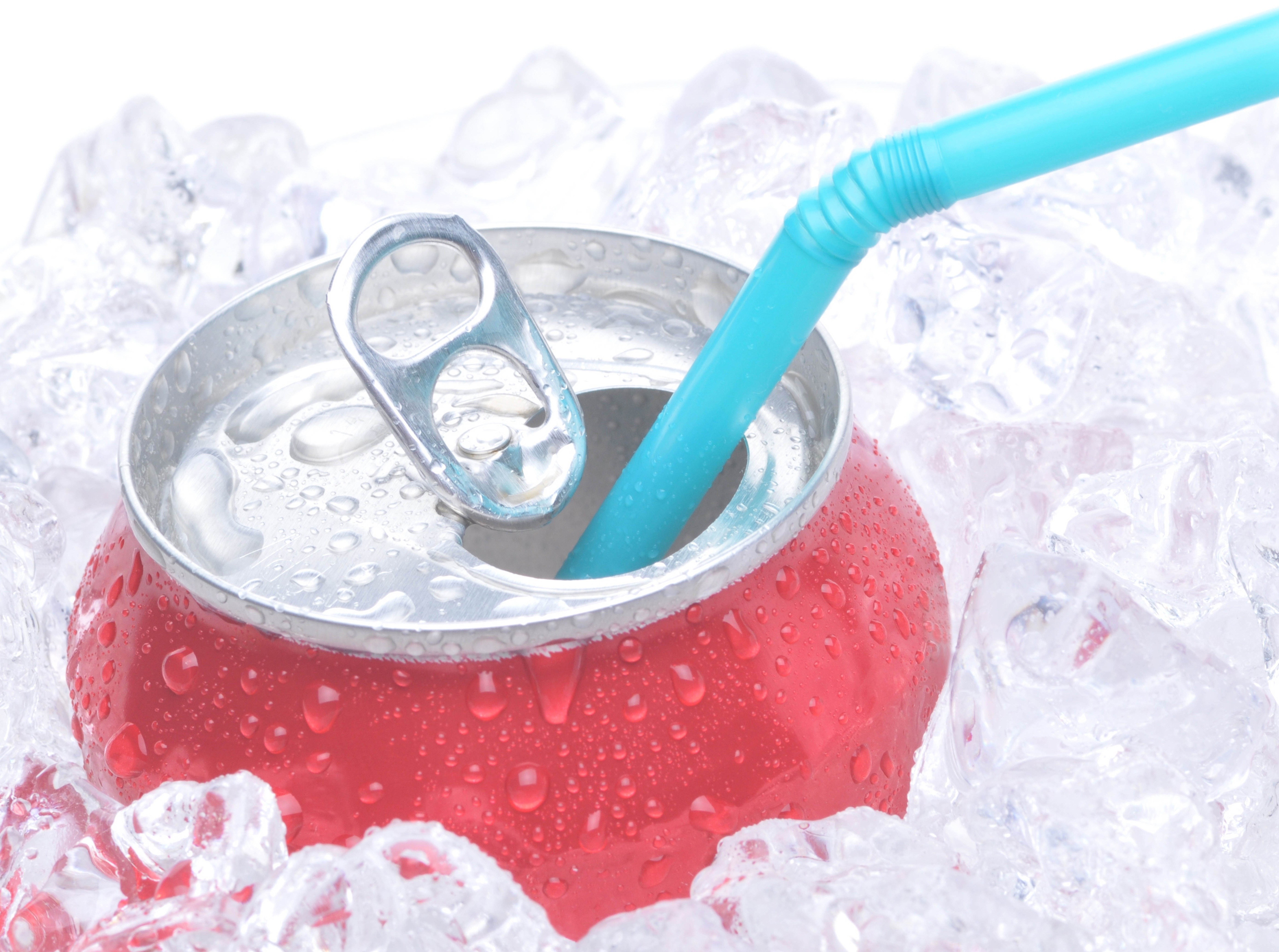 red soda can with straw