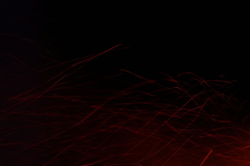 Red sparks against black background
