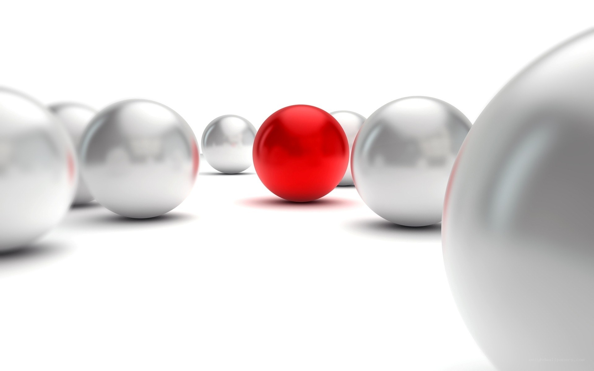 Red sphere among silver spheres