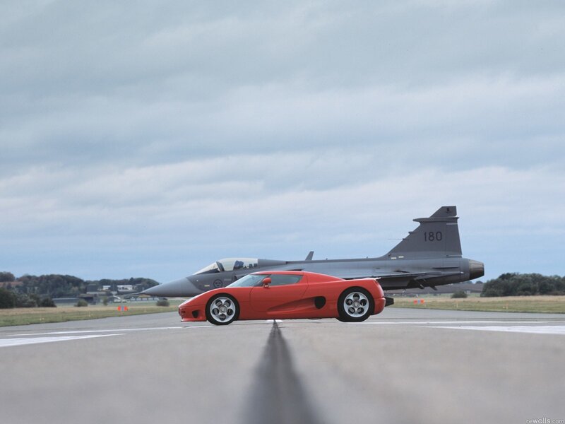 Red sports car and fighter jet