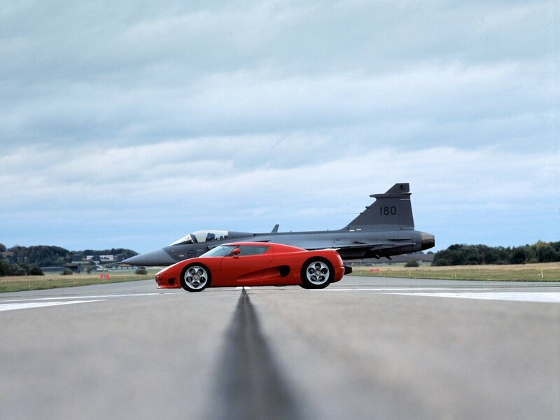 Red sports car and fighter jet