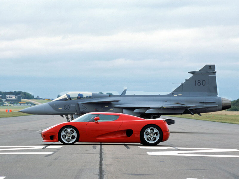 Red sports car and fighter jet
