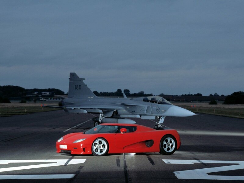 Red sports car and fighter jet