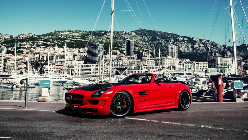 Red sports car at a marina