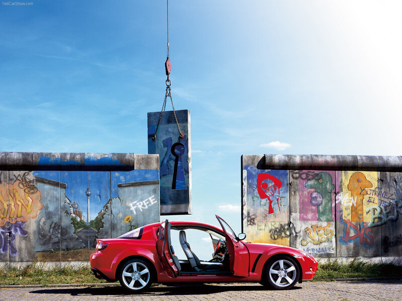 Red sports car at Berlin Wall