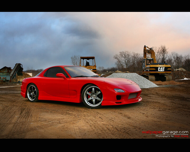 Red sports car at construction site