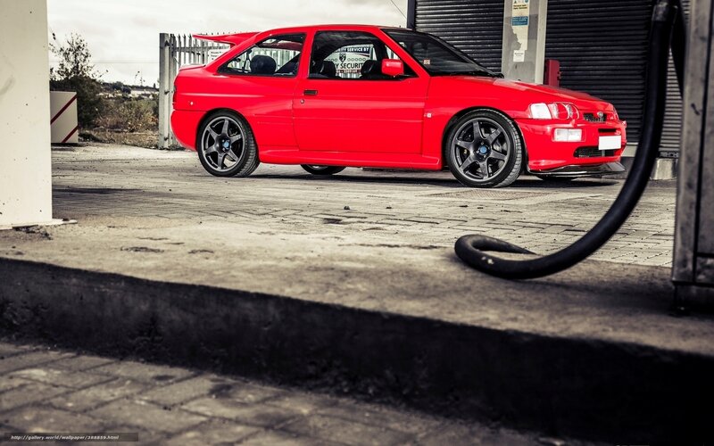 red sports car at gas station