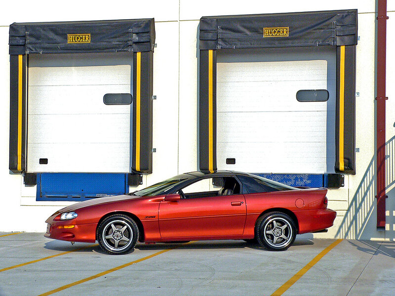 Red sports car at loading dock