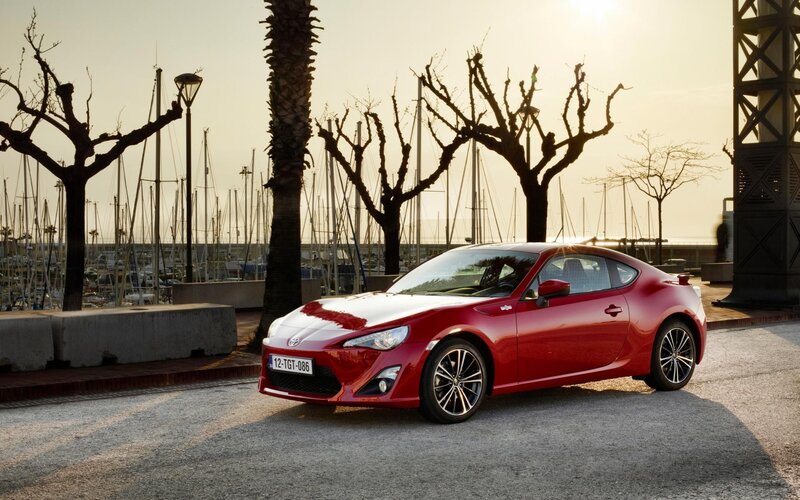 Red sports car at marina