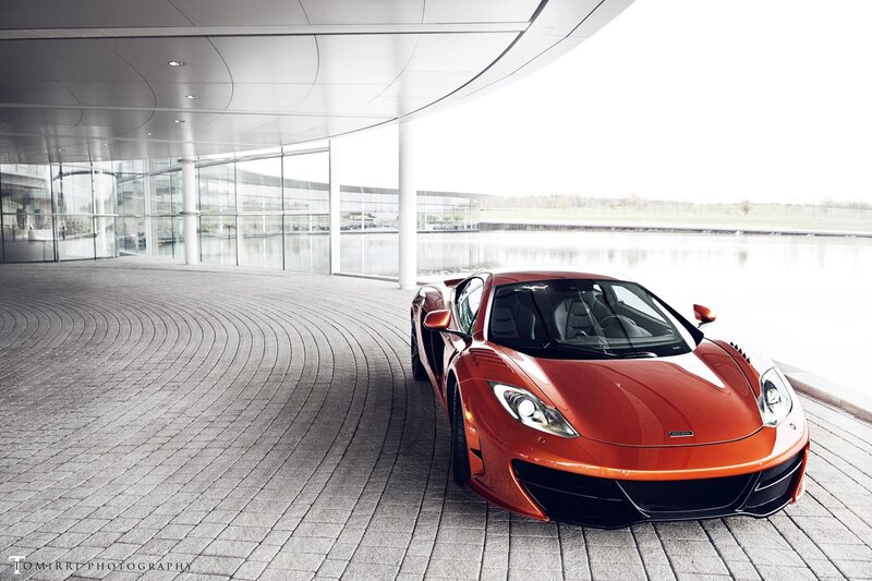 Red sports car at modern building