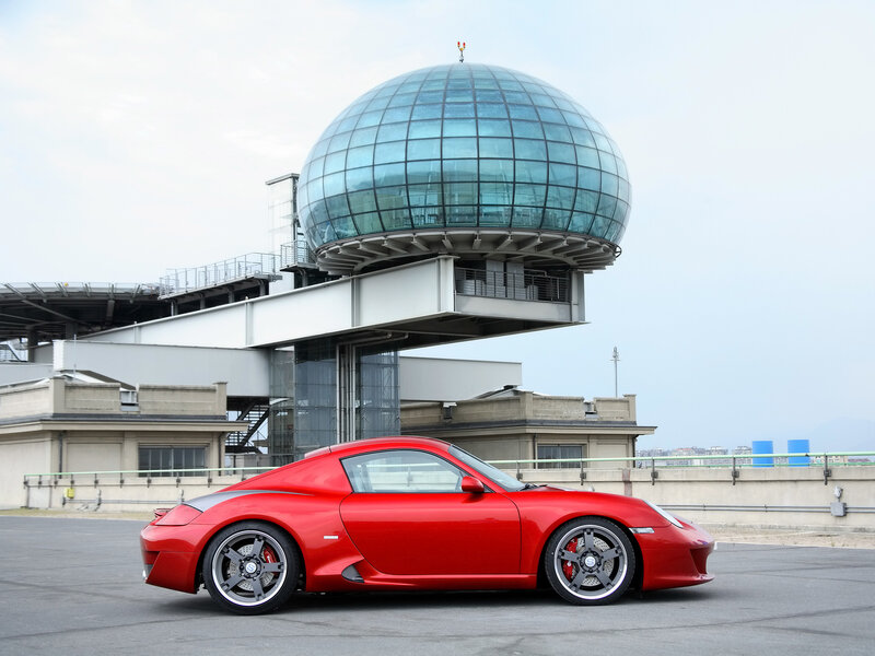 Red sports car at modern building
