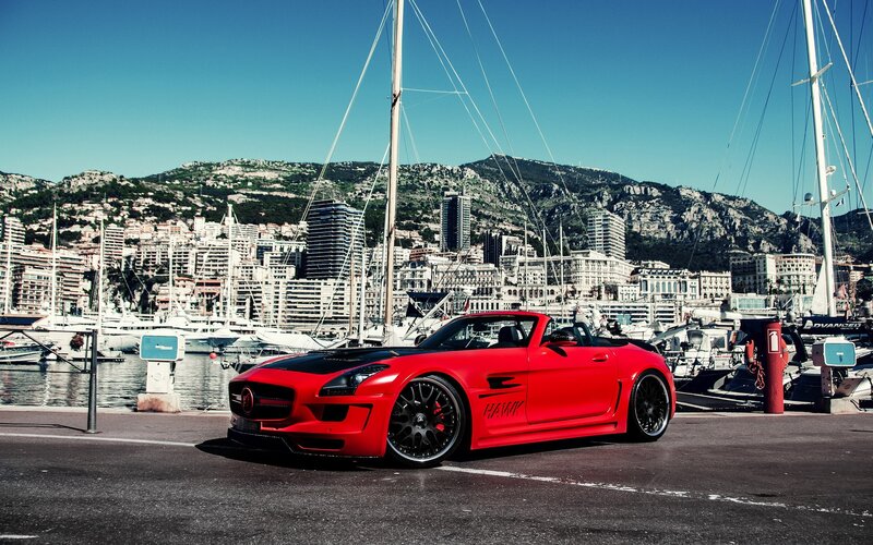 Red sports car at Monaco harbor