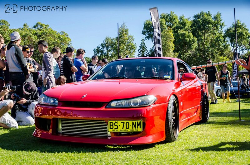 Red sports car at outdoor event