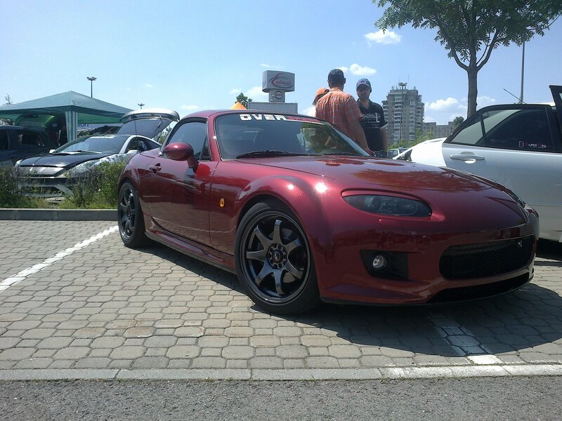 Red sports car at outdoor event