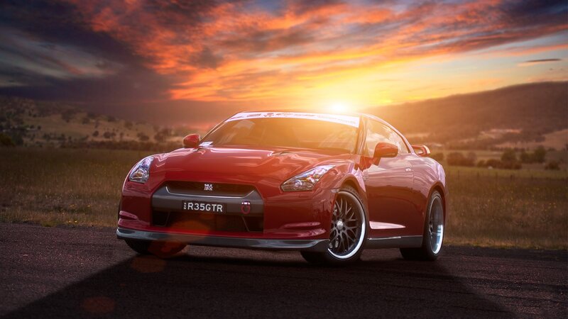 Red sports car at sunset