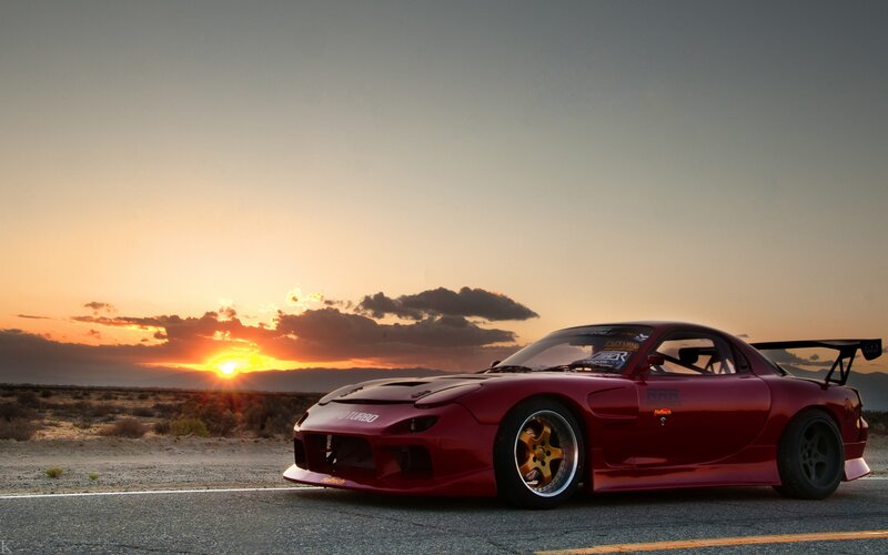 red sports car at sunset