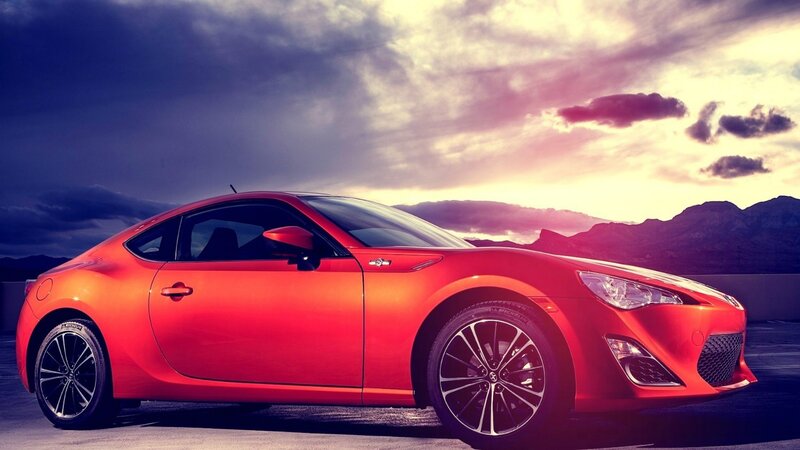 Red sports car at sunset