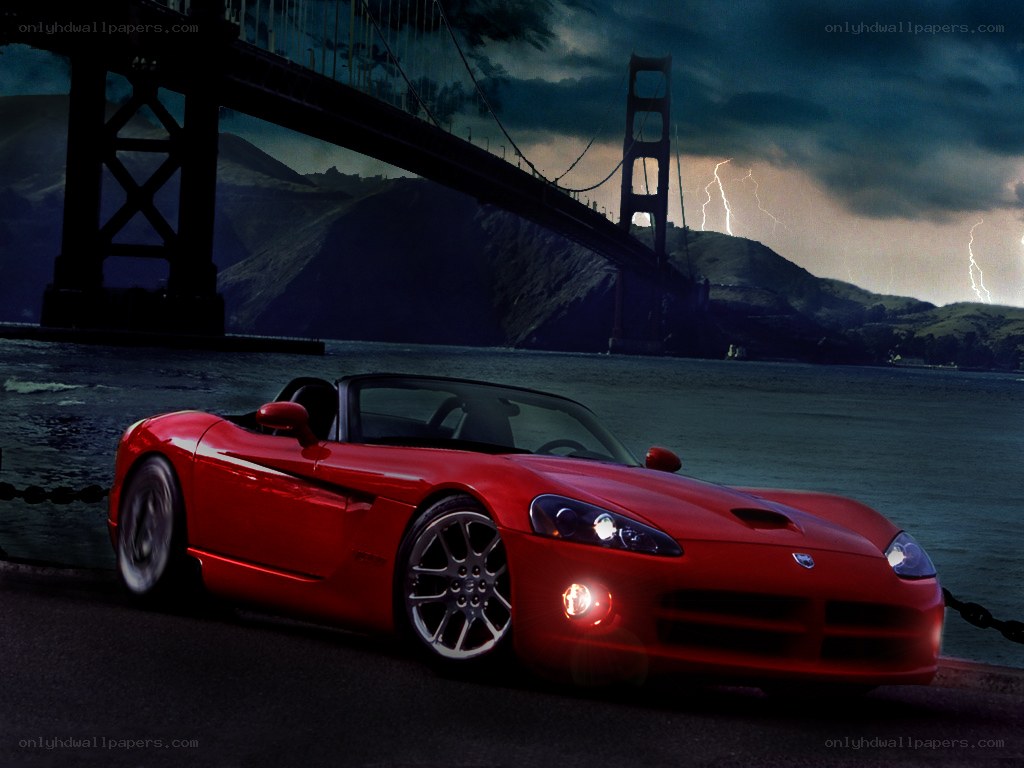 Red sports car by a bridge