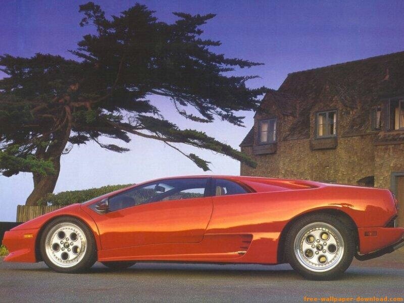 Red sports car by a house