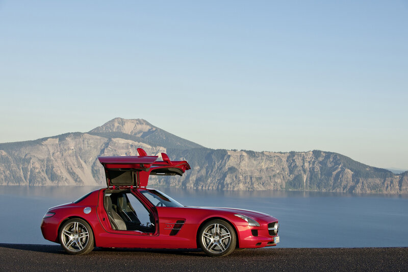 Red sports car by a lake