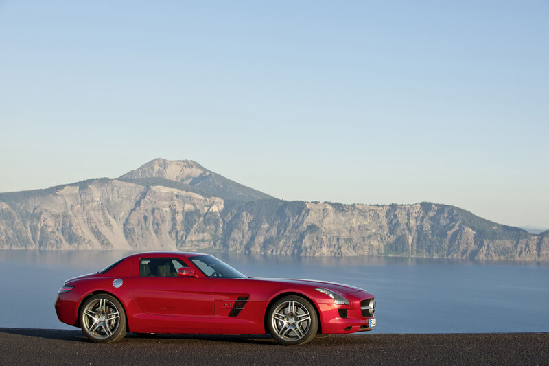 Red sports car by a lake