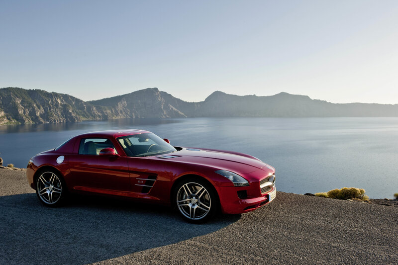 Red sports car by a lake