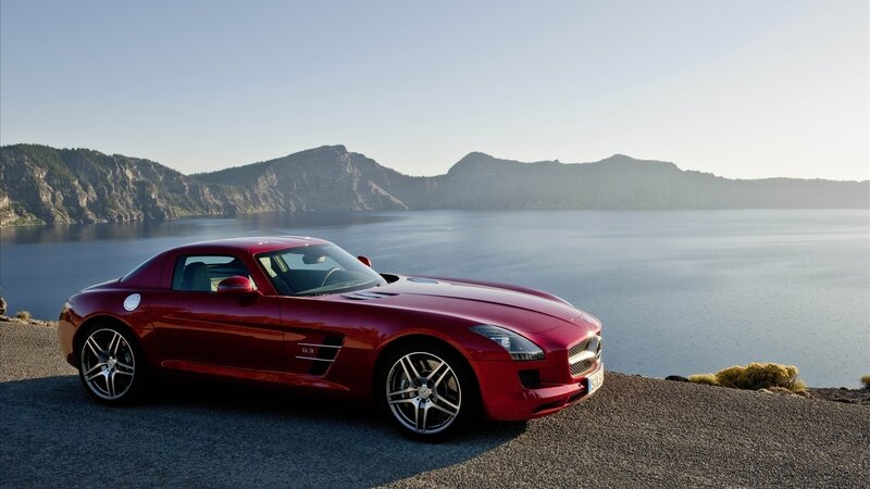 Red sports car by a lake