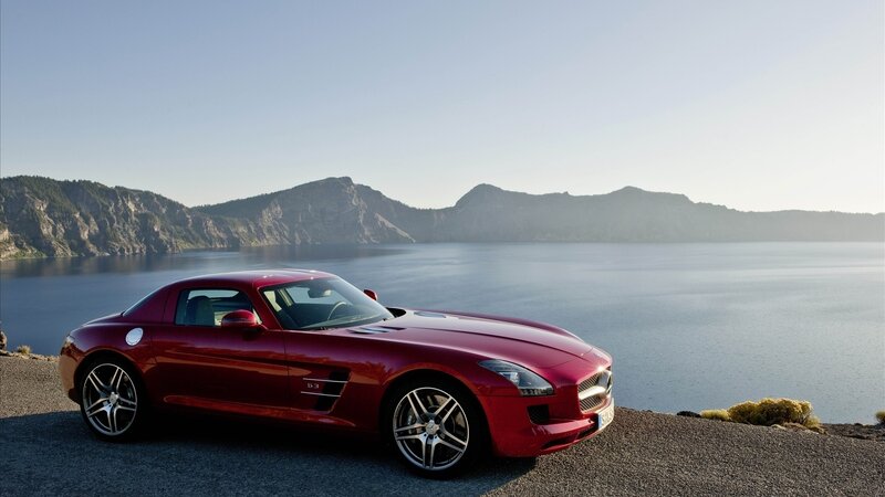 Red sports car by a lake