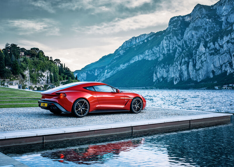 Red sports car by a lake