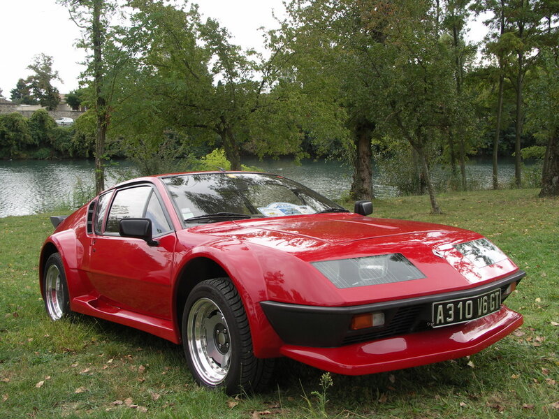 Red sports car by a river