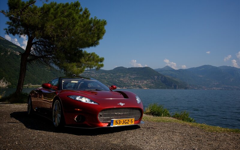 Red sports car by the lake