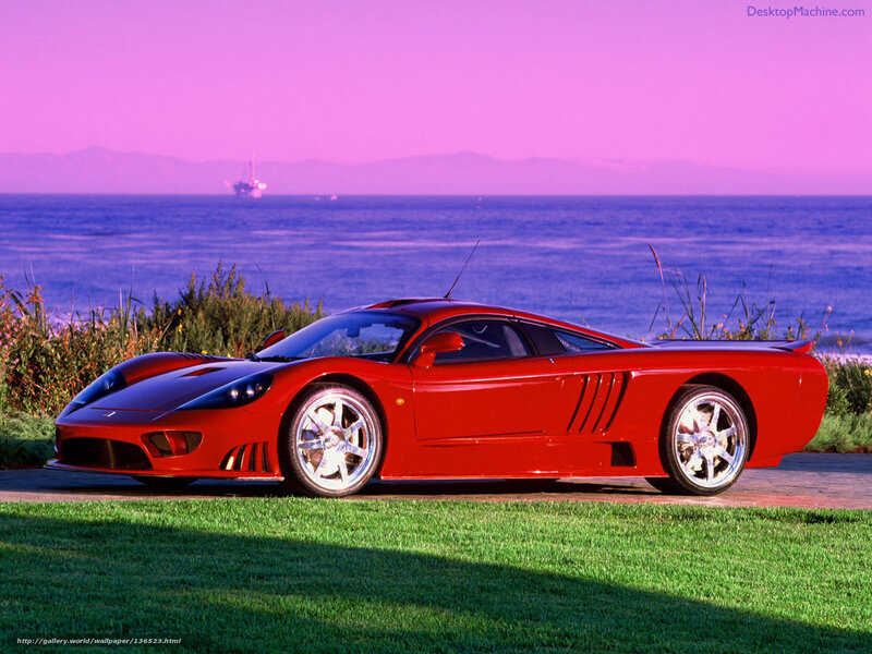 Red sports car by the ocean