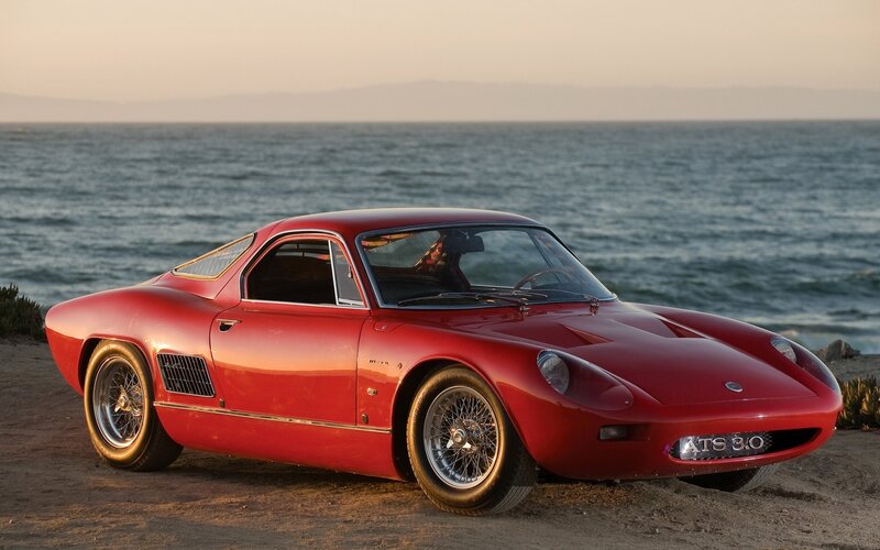 Red sports car by the sea