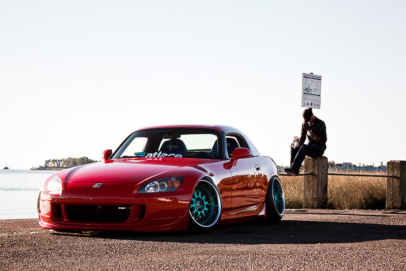 Red sports car by the water
