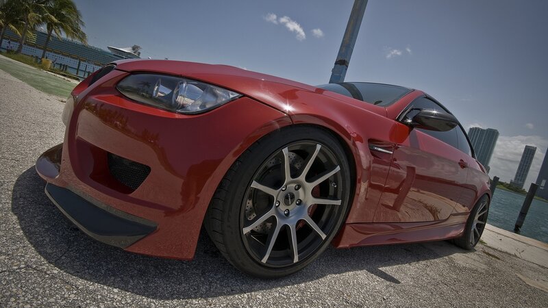 red sports car by the water