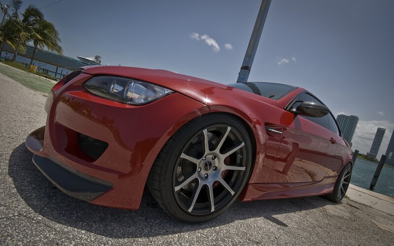 Red sports car by the water