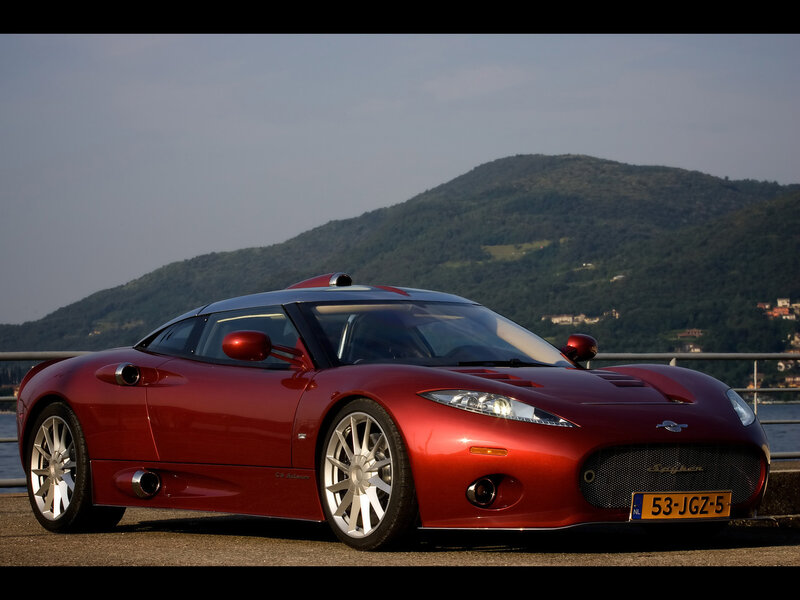 Red sports car by the water