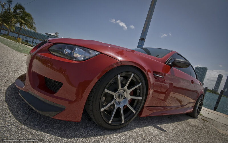Red sports car by the water