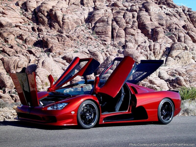 Red Sports Car — Dramatic, Afternoon, Photograph, Rocky Cliffs, Asphalt Road