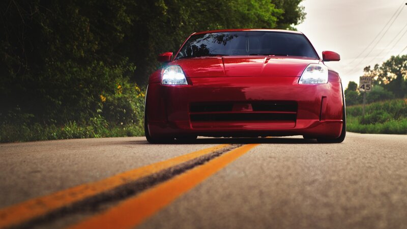 Red Sports Car — Dramatic, Sunset, Photograph, Road, Trees, Speed Limit Sign