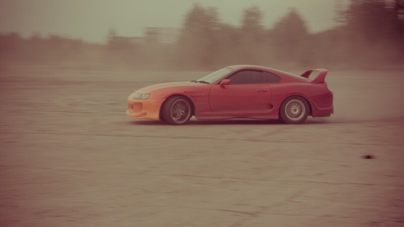 red sports car drifting