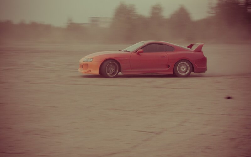 red sports car drifting