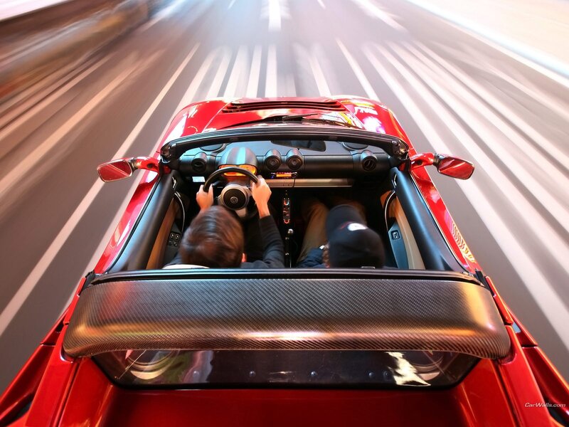 Red sports car driving fast