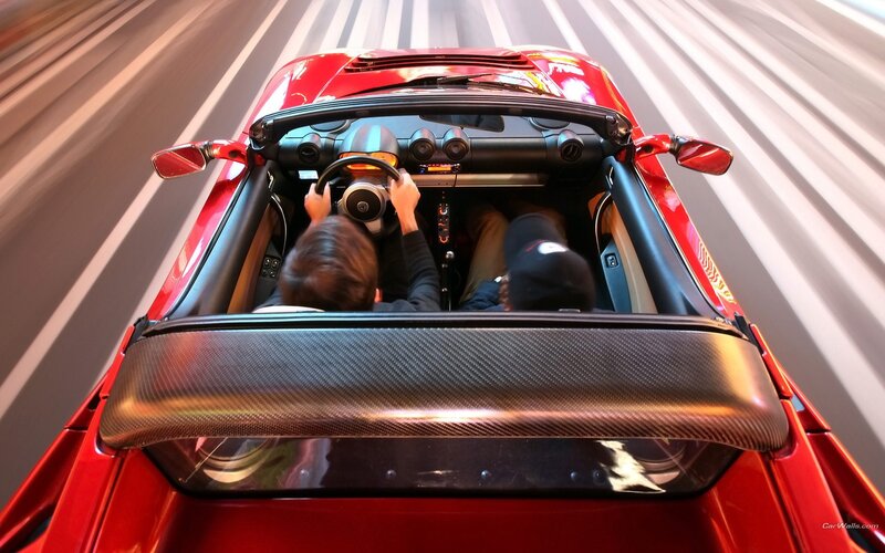 Red sports car driving fast