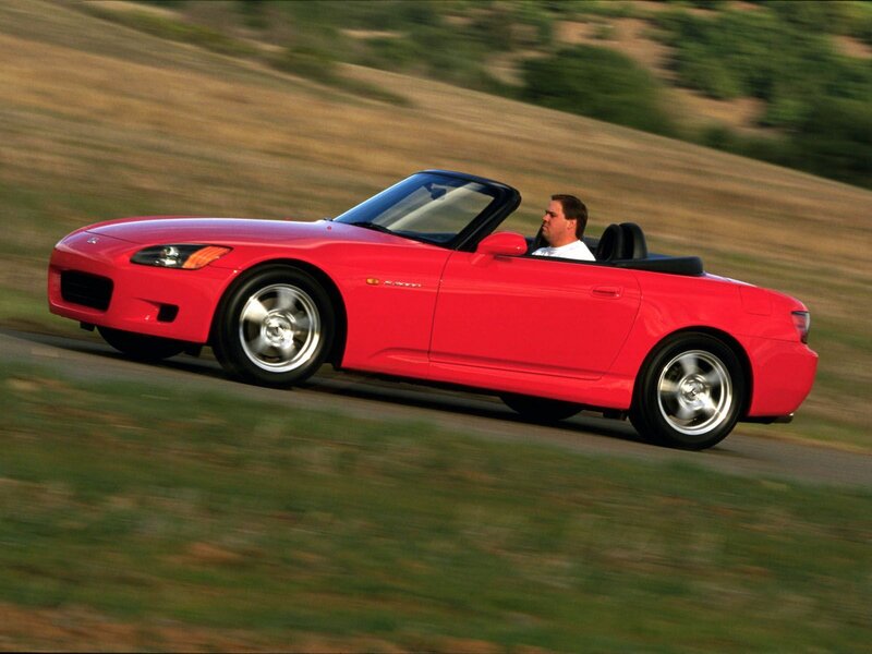 Red sports car driving on road