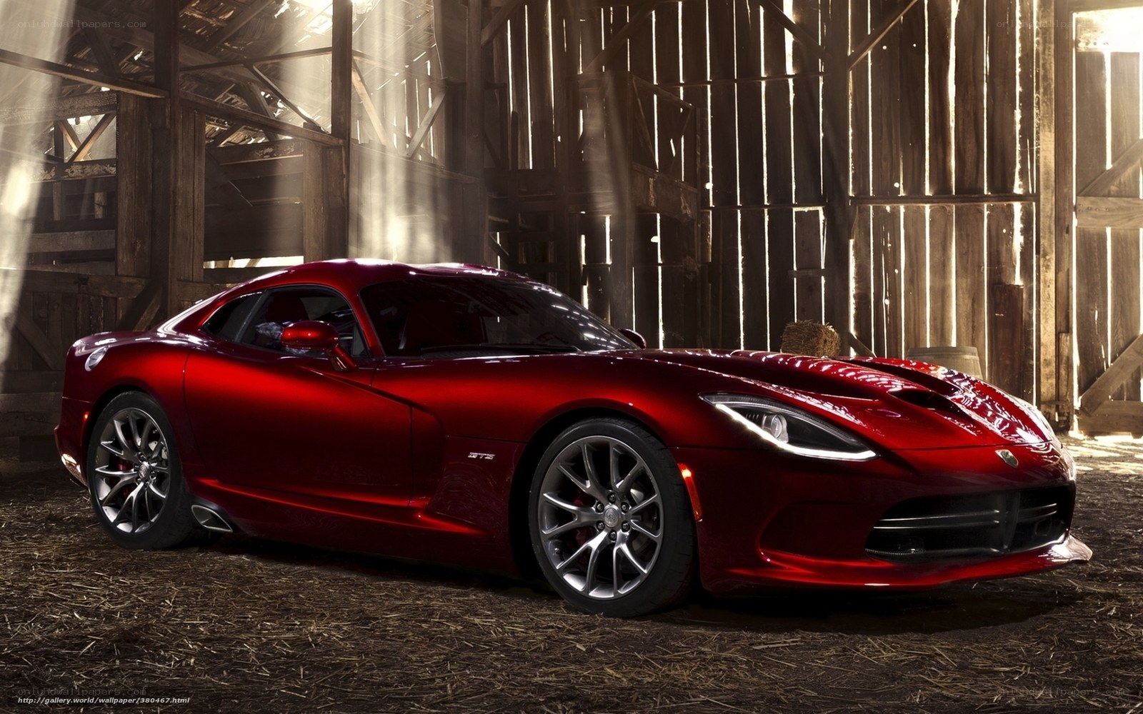 Red sports car in a barn