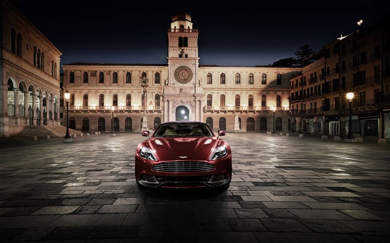 Red sports car in a city square