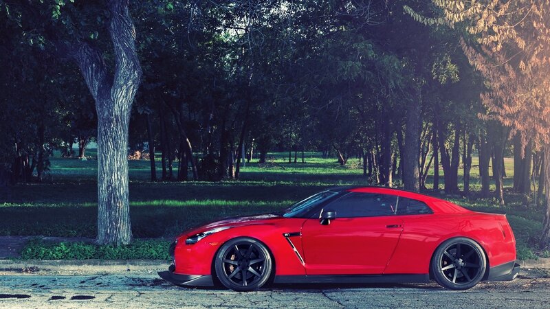 Red sports car in a park