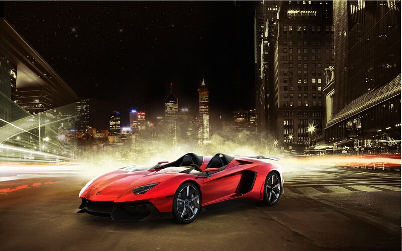 Red sports car in city at night